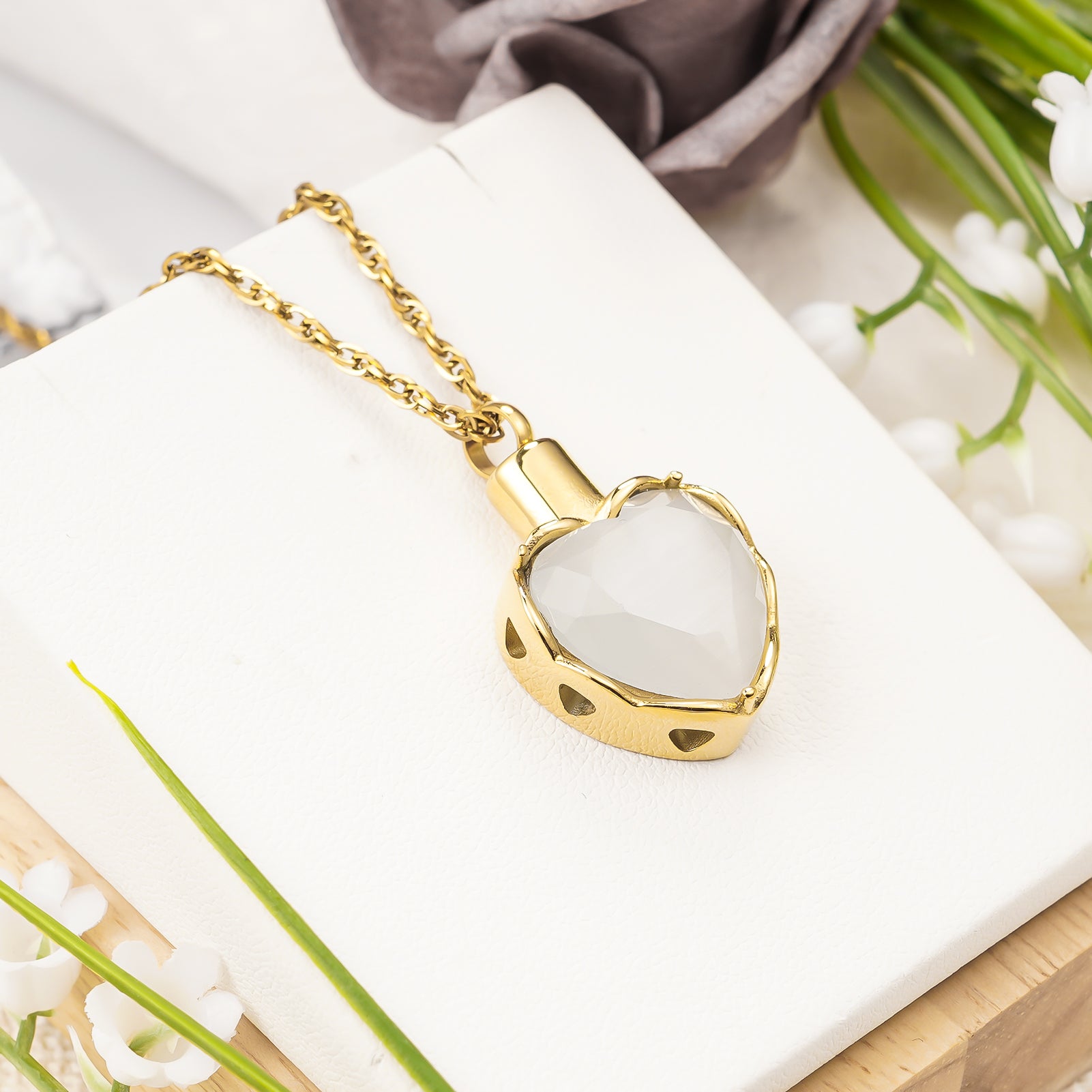 Gold heart pendant with white stone for ashes